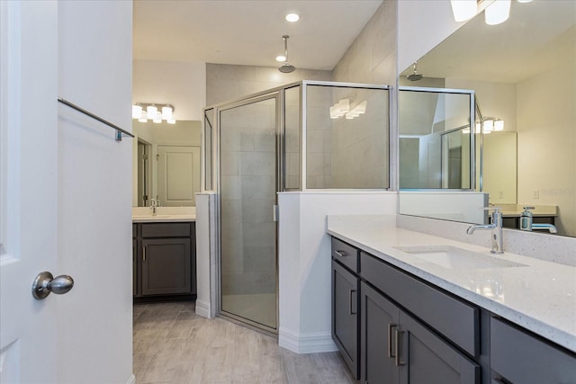 bathroom featuring vanity and a shower with shower door