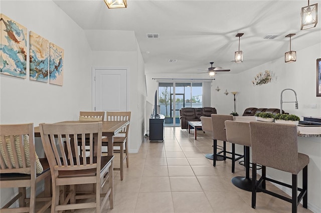 dining room with sink, light tile patterned floors, and ceiling fan