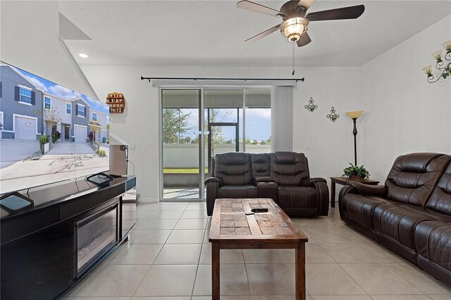 tiled living room featuring ceiling fan