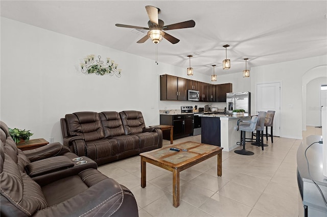 tiled living room with ceiling fan