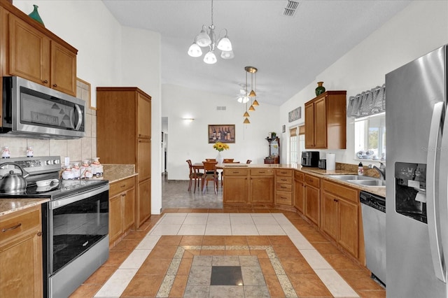 kitchen with light tile patterned floors, an inviting chandelier, stainless steel appliances, and pendant lighting