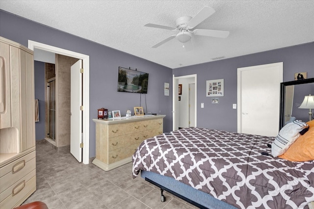 bedroom with ceiling fan and a textured ceiling