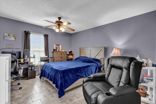 tiled bedroom with a textured ceiling and ceiling fan