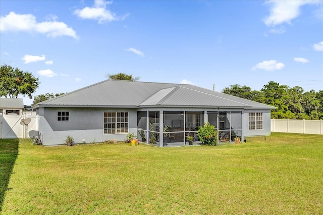 back of house featuring a yard and a sunroom