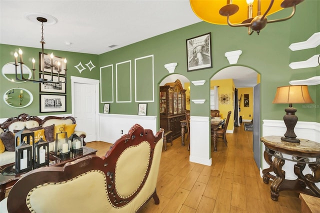 dining area with light hardwood / wood-style floors and a notable chandelier