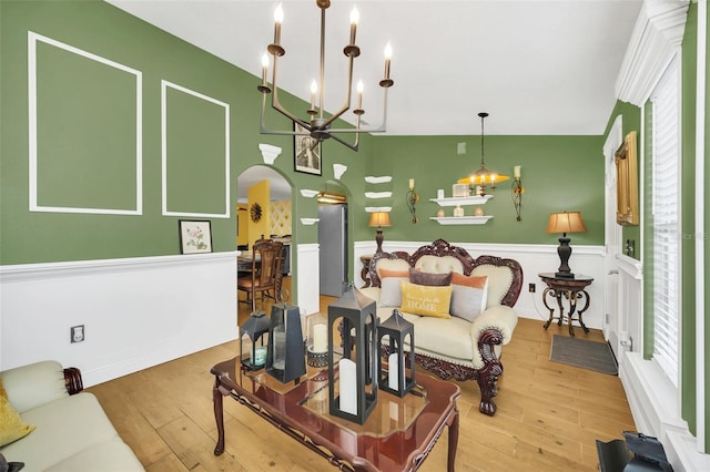 living room with lofted ceiling, hardwood / wood-style floors, and plenty of natural light