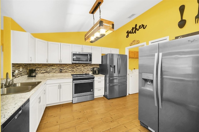 kitchen with decorative backsplash, white cabinets, decorative light fixtures, and stainless steel appliances