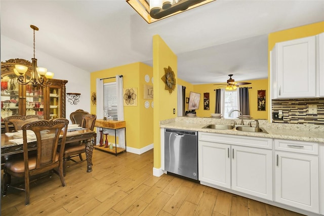 kitchen with stainless steel dishwasher, sink, white cabinets, and light hardwood / wood-style floors