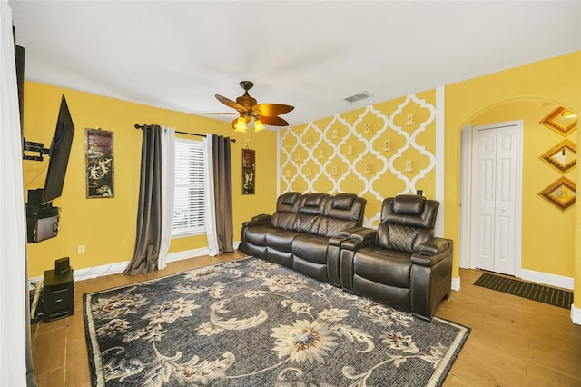 living room featuring light hardwood / wood-style flooring and ceiling fan