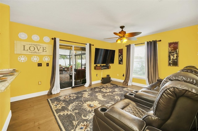 living room with ceiling fan, plenty of natural light, and hardwood / wood-style floors