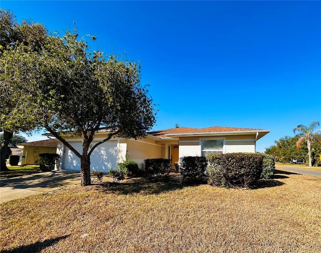 view of front of home featuring a garage and a front lawn