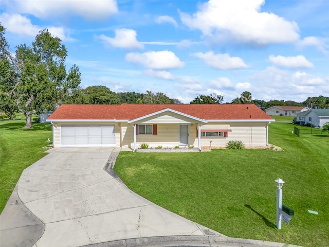 single story home featuring a garage and a front yard