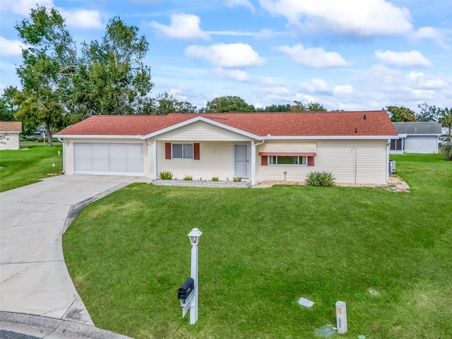 ranch-style home with a garage and a front lawn