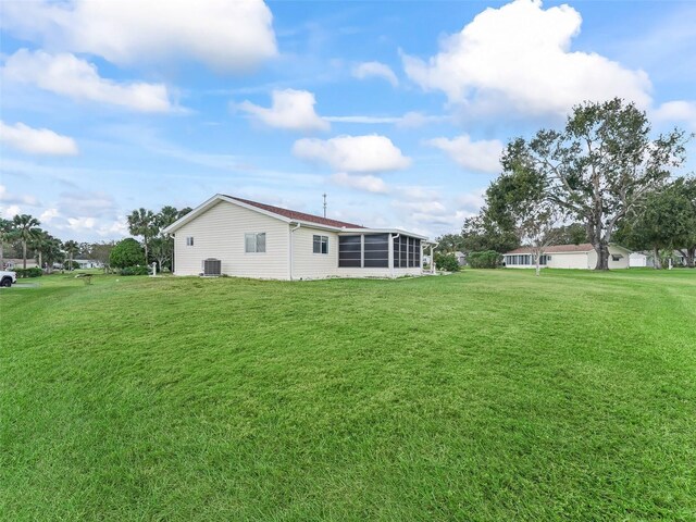 view of yard featuring cooling unit and a sunroom