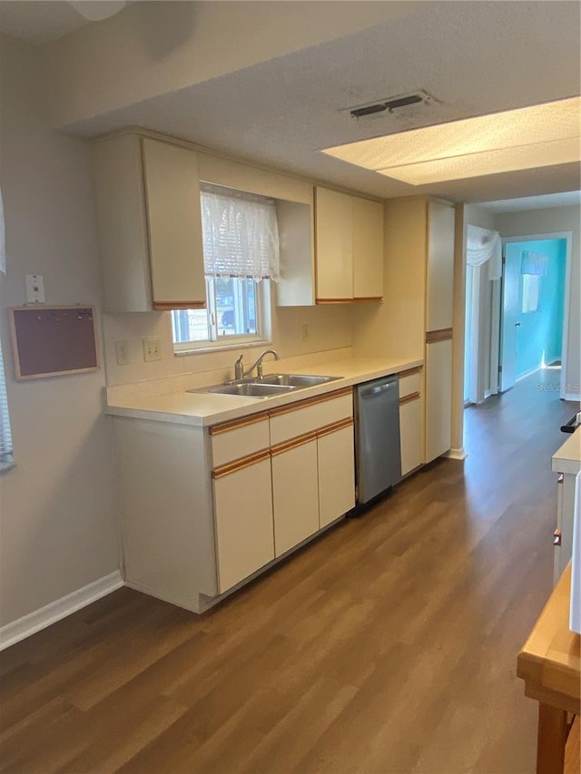 kitchen featuring a textured ceiling, dishwasher, hardwood / wood-style flooring, and sink