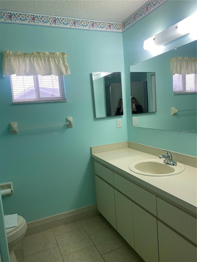 bathroom featuring toilet, vanity, and tile patterned floors