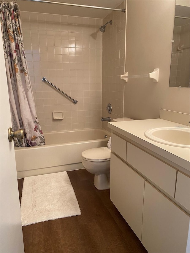 full bathroom featuring wood-type flooring, toilet, vanity, and shower / tub combo