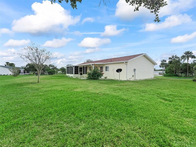 view of yard with a sunroom