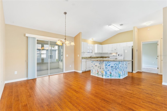 kitchen with white cabinetry, a center island, tasteful backsplash, a chandelier, and white appliances