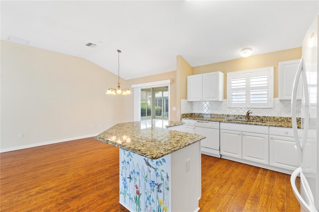 kitchen featuring decorative backsplash, white appliances, decorative light fixtures, and white cabinetry