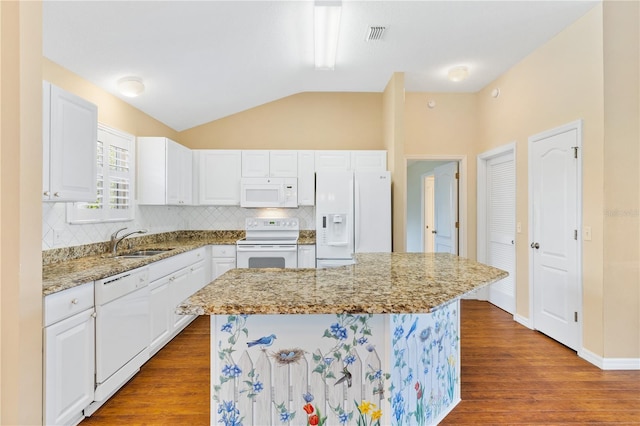 kitchen with white appliances, a kitchen island, sink, hardwood / wood-style floors, and white cabinetry