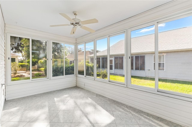 unfurnished sunroom featuring ceiling fan