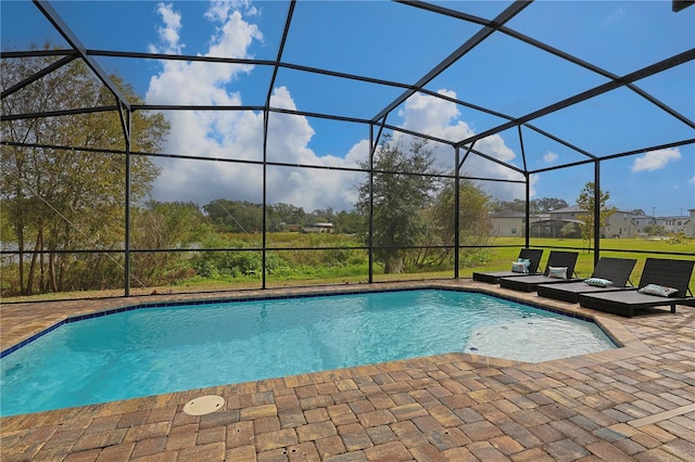 view of swimming pool with a patio and a lanai