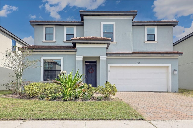 view of front of property with a front yard and a garage