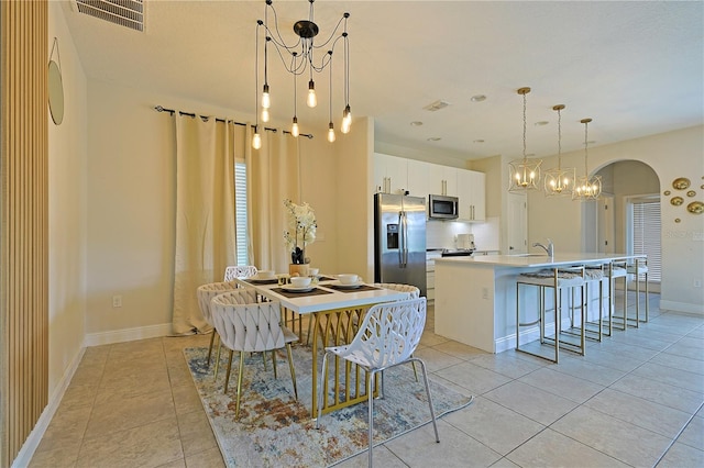 dining area with sink and light tile patterned flooring