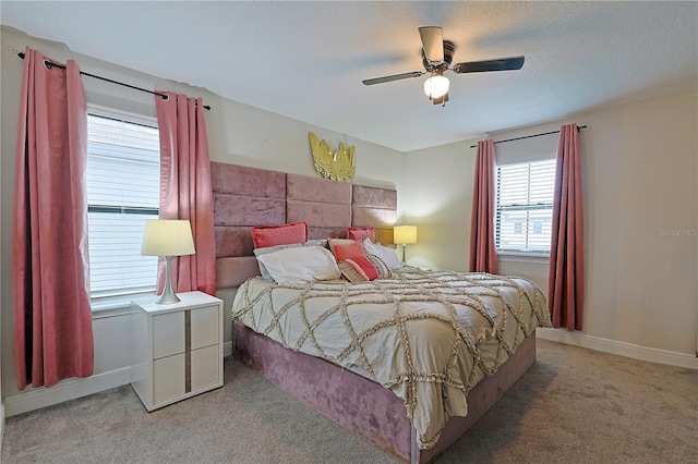 bedroom with light carpet, a textured ceiling, and ceiling fan