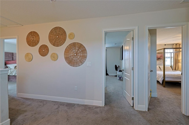 hallway with light colored carpet