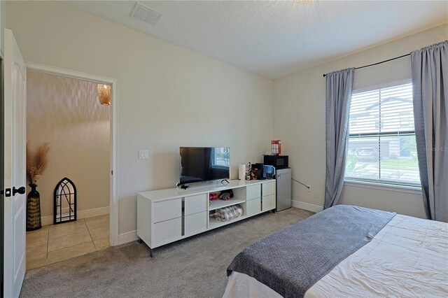 carpeted bedroom with a textured ceiling