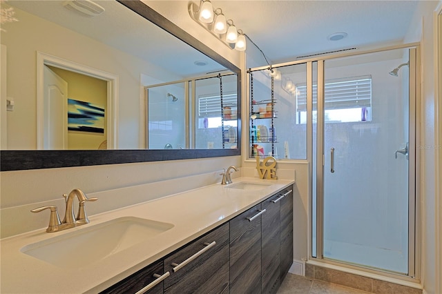 bathroom with vanity, walk in shower, and plenty of natural light