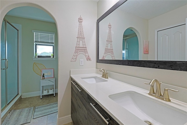 bathroom featuring vanity, tile patterned flooring, and a shower with door