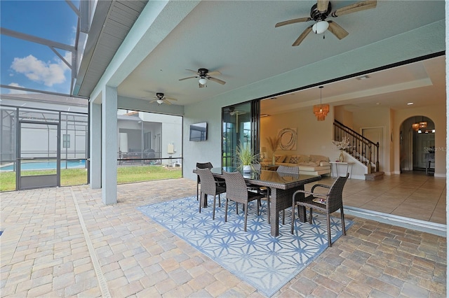 view of patio with glass enclosure and ceiling fan