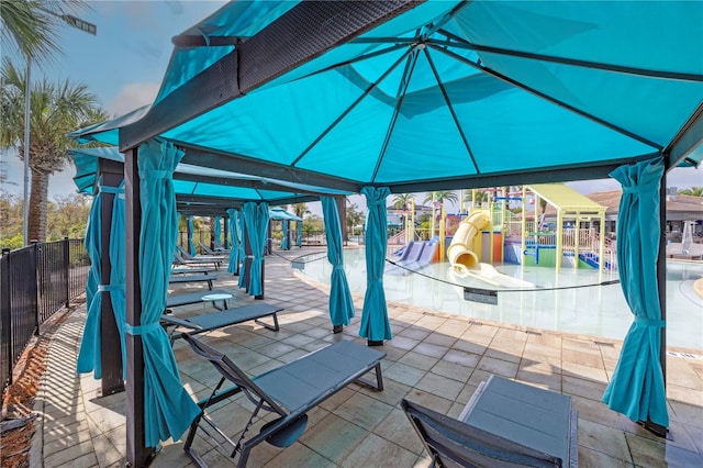 view of patio featuring a gazebo and a community pool