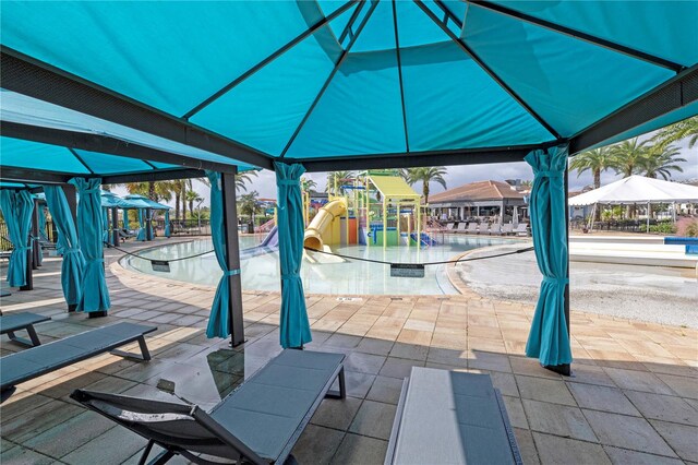 view of patio / terrace with a gazebo and a community pool