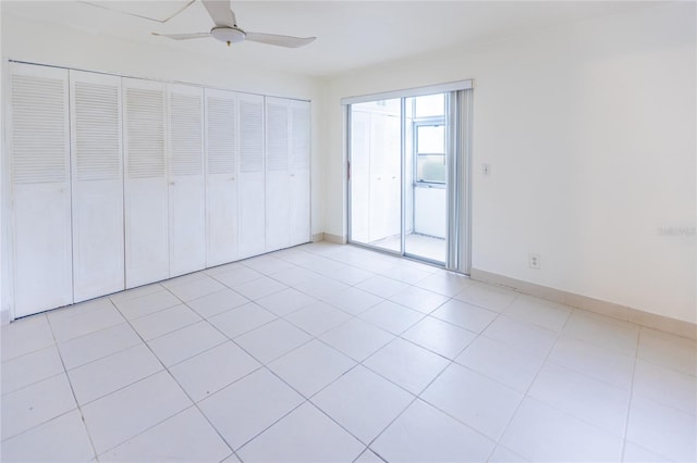 unfurnished bedroom featuring light tile patterned floors, a closet, and ceiling fan