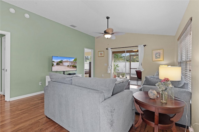 living room featuring ceiling fan, wood-type flooring, and lofted ceiling