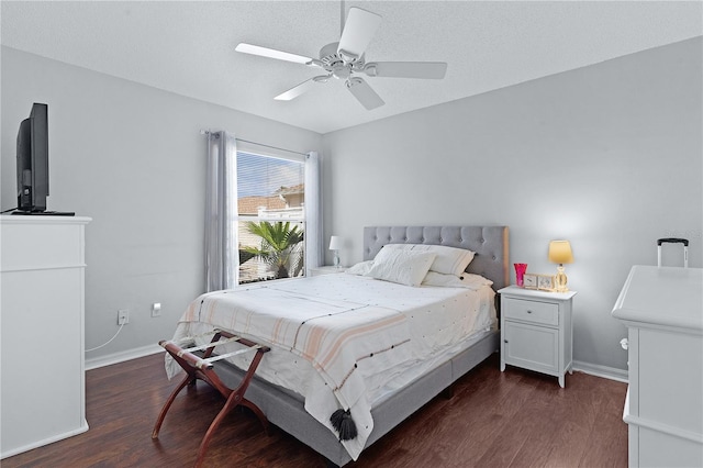 bedroom featuring ceiling fan, a textured ceiling, and dark hardwood / wood-style flooring