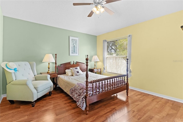 bedroom featuring a textured ceiling, hardwood / wood-style flooring, and ceiling fan