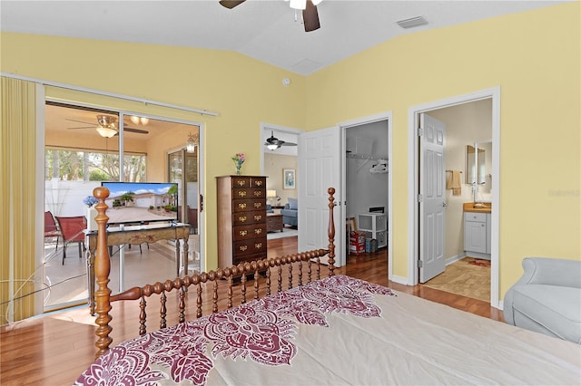 bedroom with a spacious closet, ensuite bath, a closet, and wood-type flooring