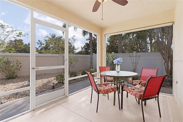 sunroom / solarium featuring ceiling fan