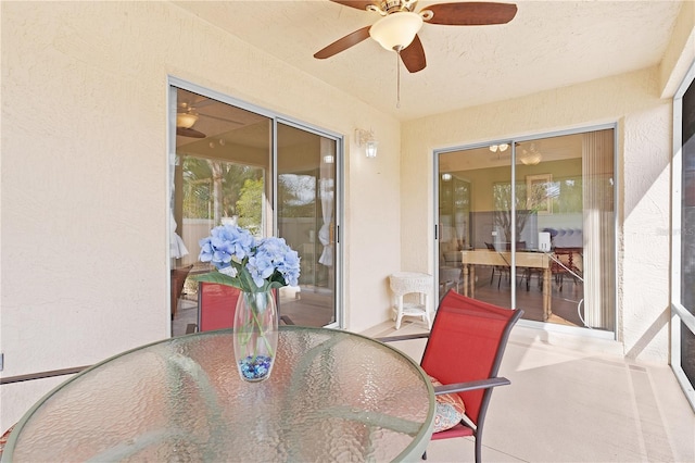 sunroom featuring ceiling fan