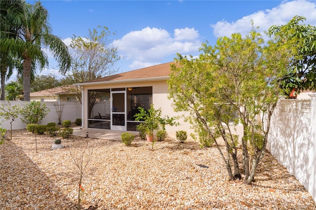 rear view of property with a sunroom