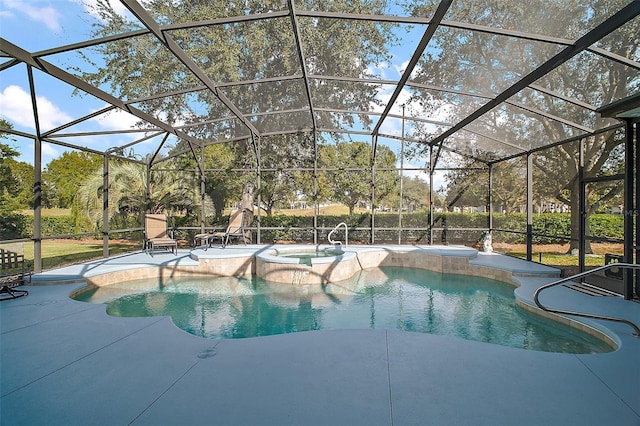 view of pool with glass enclosure, an in ground hot tub, and a patio area