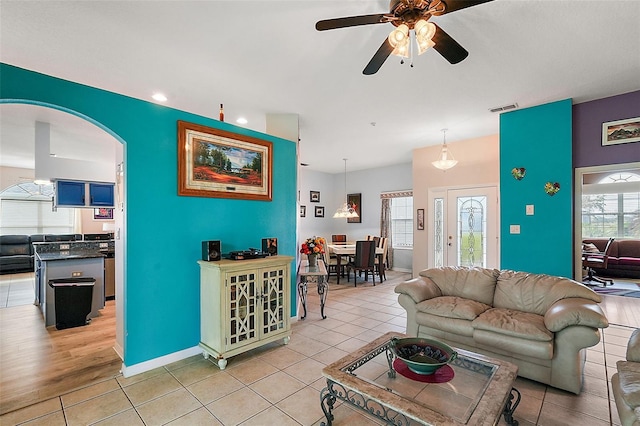 living room featuring ceiling fan and light wood-type flooring