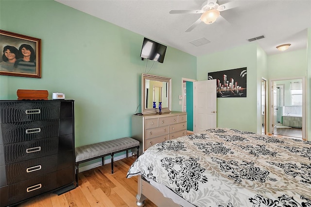 bedroom with ceiling fan, connected bathroom, and light hardwood / wood-style flooring