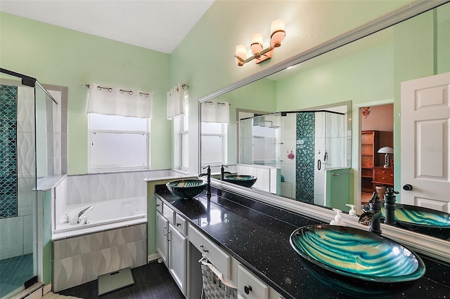 bathroom with vanity and independent shower and bath