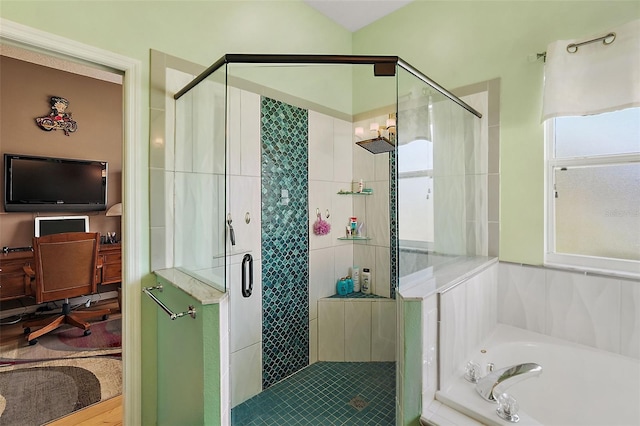 bathroom with separate shower and tub and plenty of natural light